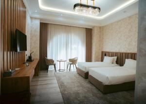 a hotel room with two beds and a table at Baden-Baden Hotel Tashkent in Tashkent