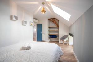 a bedroom with a bed with two white shoes on it at Les Grandes Vagastines in Saint-Germain-du-Plain +76 photos