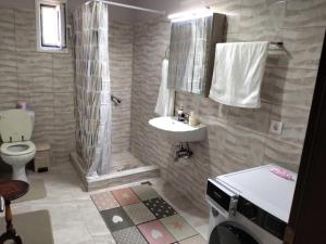 a bathroom with a sink and a toilet at Bee happy in Agioi Apostoli +13 photos