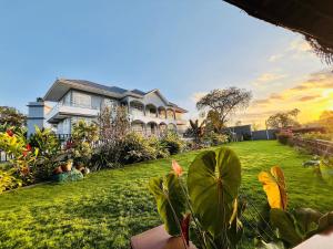 a house with a yard with green grass at Stargate Apartments in Arusha