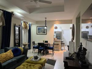 a living room with a couch and a dining room at Oceanpointe Serenity Get Away-solar pool WiFi in Lucea