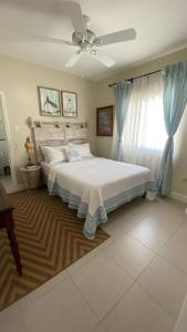a bedroom with a bed and a ceiling fan at Oceanpointe Serenity Get Away-solar pool WiFi in Lucea +43 photos