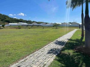 a cobblestone path in a field with palm trees at Oceanpointe Serenity Get Away-solar pool WiFi in Lucea