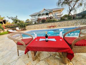 a table with a bottle of wine on top at Stargate Apartments in Arusha