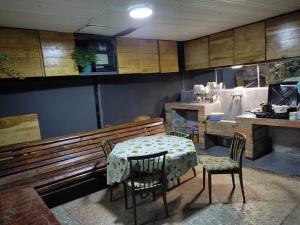 a dining room with a table and chairs and a kitchen at Guest House Guro kobuleti in Kobuleti