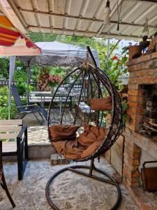 a swing chair sitting on a patio at Guest House Guro kobuleti in Kobuleti