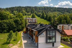 an aerial view of a house with a roof at Aparthotel Pod Stokiem z sauną i jacuzzi - szczyrkapartamenty in Szczyrk