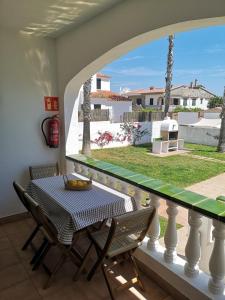 a table and chairs on a balcony with a view at Nice apartment with a pool in Fornells