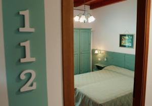 a bedroom with a bed and a mirror at Posada di Portixeddu in Portixeddu