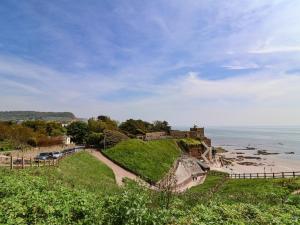 an old castle on a hill next to the ocean at The Milk Shed in Plymtree