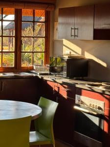 a kitchen with a table and a table and chairs at Vilagama Game Lodge in Naboomspruit