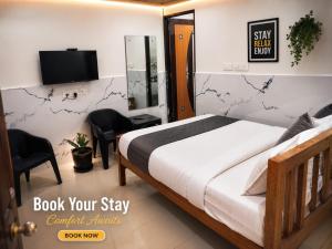 a bedroom with a bed and a tv in a room at Wayan Luxury Rooms in Hyderabad