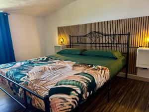 a bedroom with a large bed with a wooden headboard at Residenza De Vita in Tropea