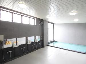 a swimming pool in a room with a pool at ホテルいづみや in Aizuwakamatsu