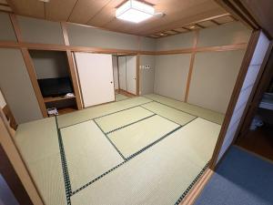 an empty room with a net in the middle at ホテルいづみや in Aizuwakamatsu