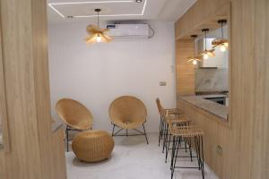 a kitchen with chairs and a table and a counter at Luxury Beachfront Villa with Pool and Jacuzzi in Hennchir Ksar Rhaleb