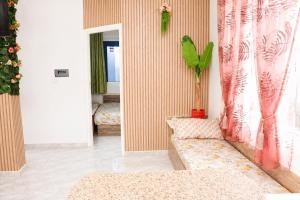 a living room with a couch and a window at Luxury Beachfront Villa with Pool and Jacuzzi in Hennchir Ksar Rhaleb