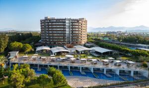 an aerial view of a large building with a pool at Nirvana Cosmopolitan Hotel in Lara