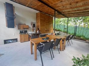 a dining room with a wooden table and chairs at Casa Stejaru in Băile Govora