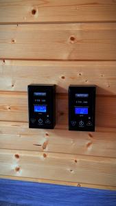 two switches on a wooden wall at Capsule & Enesai Hotels Karakol in Karakol