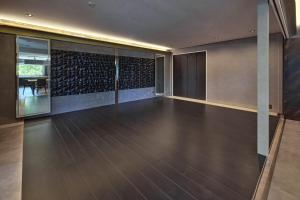 a room with a dance floor with a wall of wine bottles at Sauna Villa Biwako Forest Bathing in Takashima