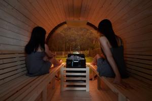 two women sitting in a igloo in a room at Sauna Villa Biwako Forest Bathing in Takashima