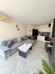 a living room with a couch and a table at Atlantis Resort Nikol in Burgas