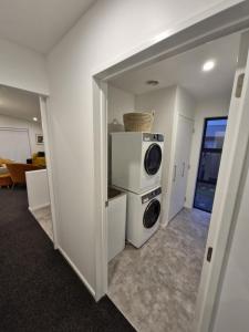 a laundry room with a washer and dryer at Modern Omarama Getaway in Omarama +6 photos