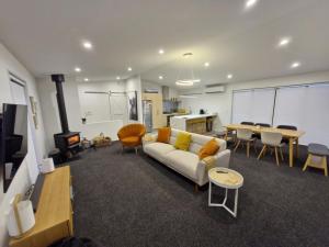 a living room with a couch and a table at Modern Omarama Getaway in Omarama