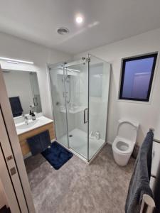 a bathroom with a shower and a toilet and a sink at Modern Omarama Getaway in Omarama