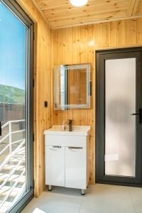 a bathroom with a sink and a mirror at Capsule & Enesai Hotels Karakol in Karakol +51 photos