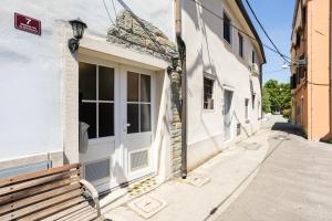 a bench sitting on a sidewalk next to a building at Casa Riccobon in Koper