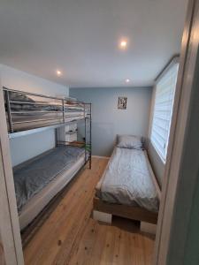 a bedroom with two bunk beds and a window at Domki Spore in Spore