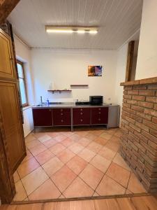 an empty room with a counter and a brick wall at Naturblick in Neresheim