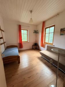 a bedroom with a bed and two windows at Naturblick in Neresheim