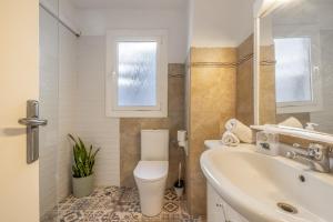 a white bathroom with a toilet and a sink at Cambrils in Cambrils +25 photos