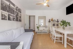 a living room with a white couch and a table at Cambrils in Cambrils