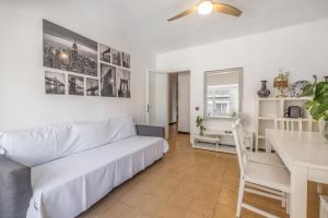 a living room with a white couch and a table at Cambrils in Cambrils