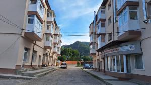 an alley between two buildings with a car parked on the street at MaraStudio in Caşoca