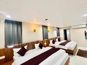 a hotel room with two beds in a room at Hotel Sunshine Apartment in Bathinda +64 photos