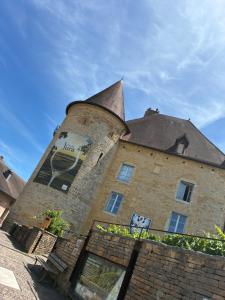 a large building with a turret on top of it at Le 36 du prieuré in Arbois