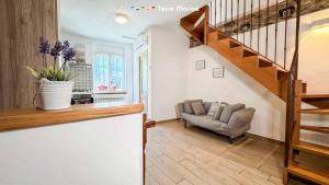 a living room with a staircase and a couch at Il Volto, Terre Marine in Pignone