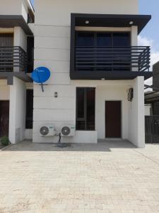 a house with a blue balloon on the side of it at 5and6 Apartments in Abuja
