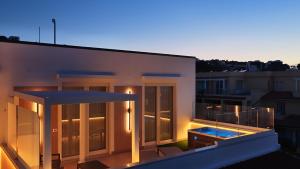 a balcony of a building with a swimming pool at Manoli Luxury Rooms in Vieste