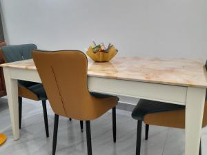 a table with two chairs and a bowl of pens at 5and6 Apartments in Abuja