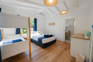 a bedroom with two beds and a bathroom at Great Keppel Island Hideaway in Great Keppel
