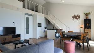 a living room with a couch and a table at Residentie De Zeester | De Schelp in Scherpenisse