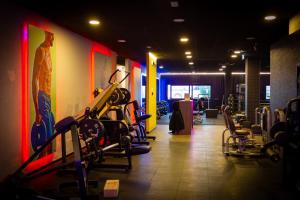 a gym with several tread machines on the wall at Dimora Coloré in Nereto