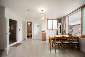 a kitchen and dining room with a table and chairs at Stay ongyeol in Suwon