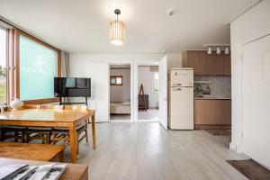 a kitchen and dining room with a table and a refrigerator at Stay ongyeol in Suwon +27 photos